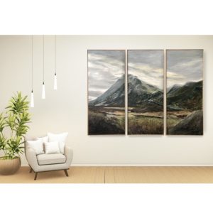 a triptych hanging on the wall with a cream chair for size perspective